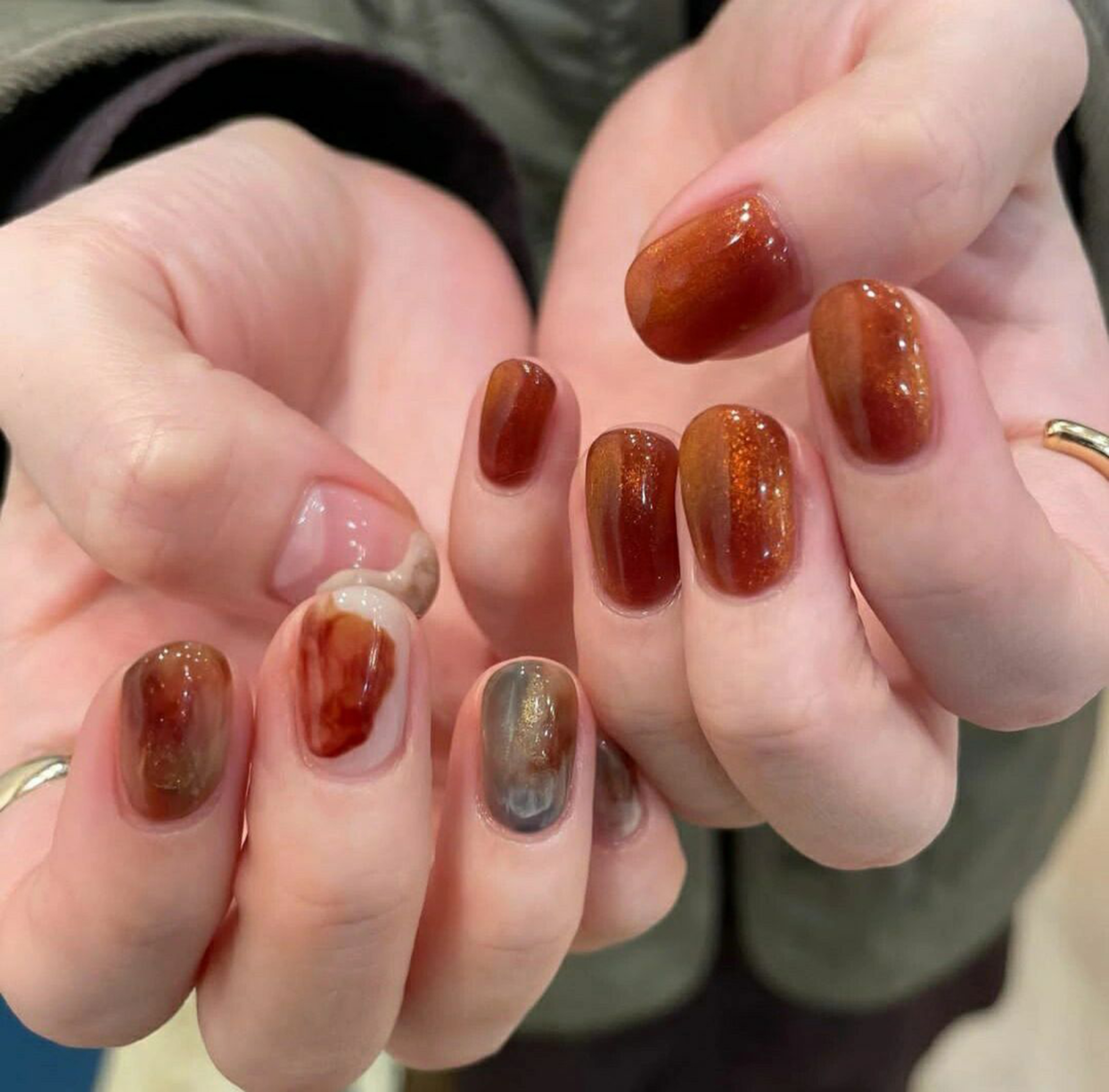 Brown and Dark Red Glitter Short Oval Nails shown as a nail art design with brown, dark red, glitter, marble, oval and short details.