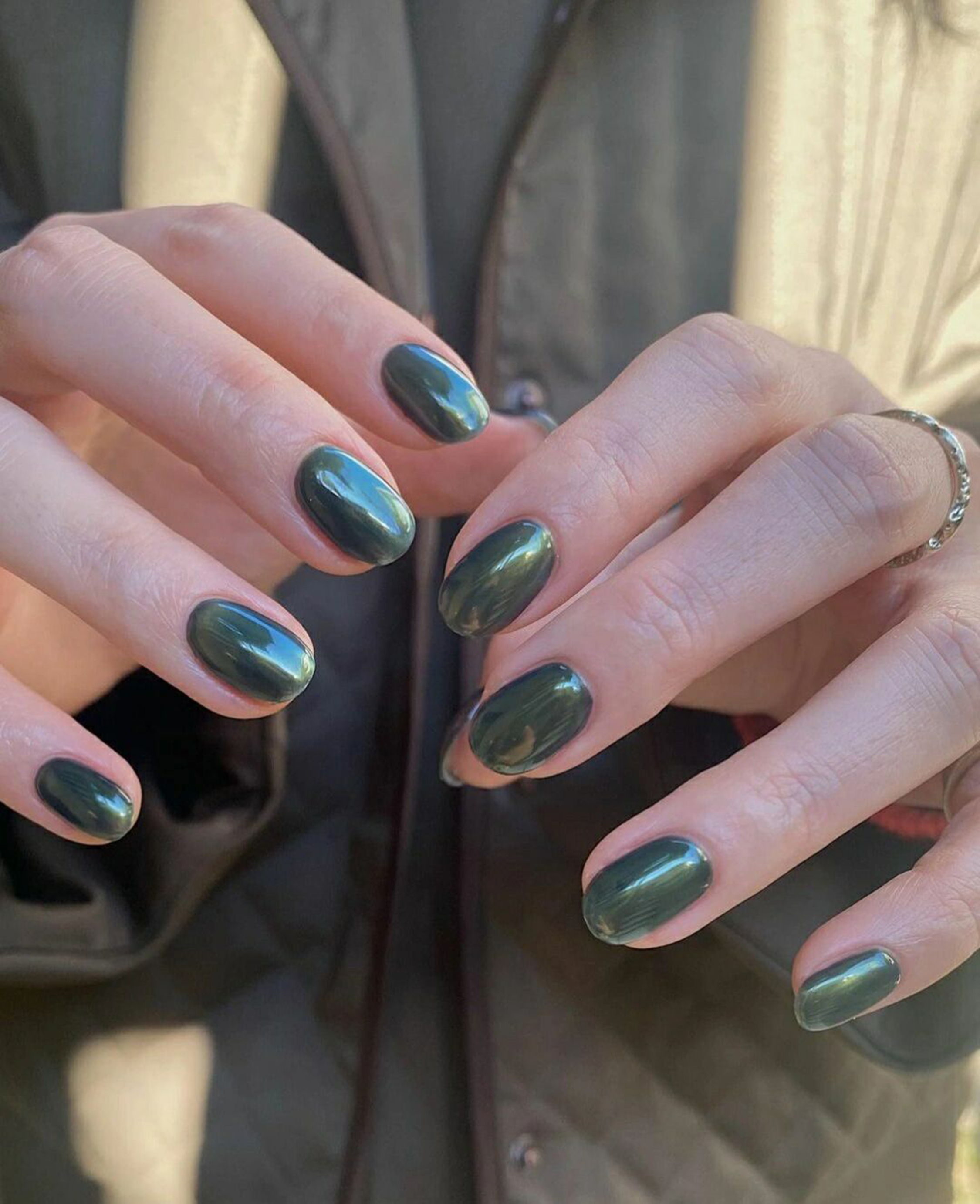 Green Cat Eye Oval Nails shown as a nail art design with green, cat eye, elegant, oval and medium details.